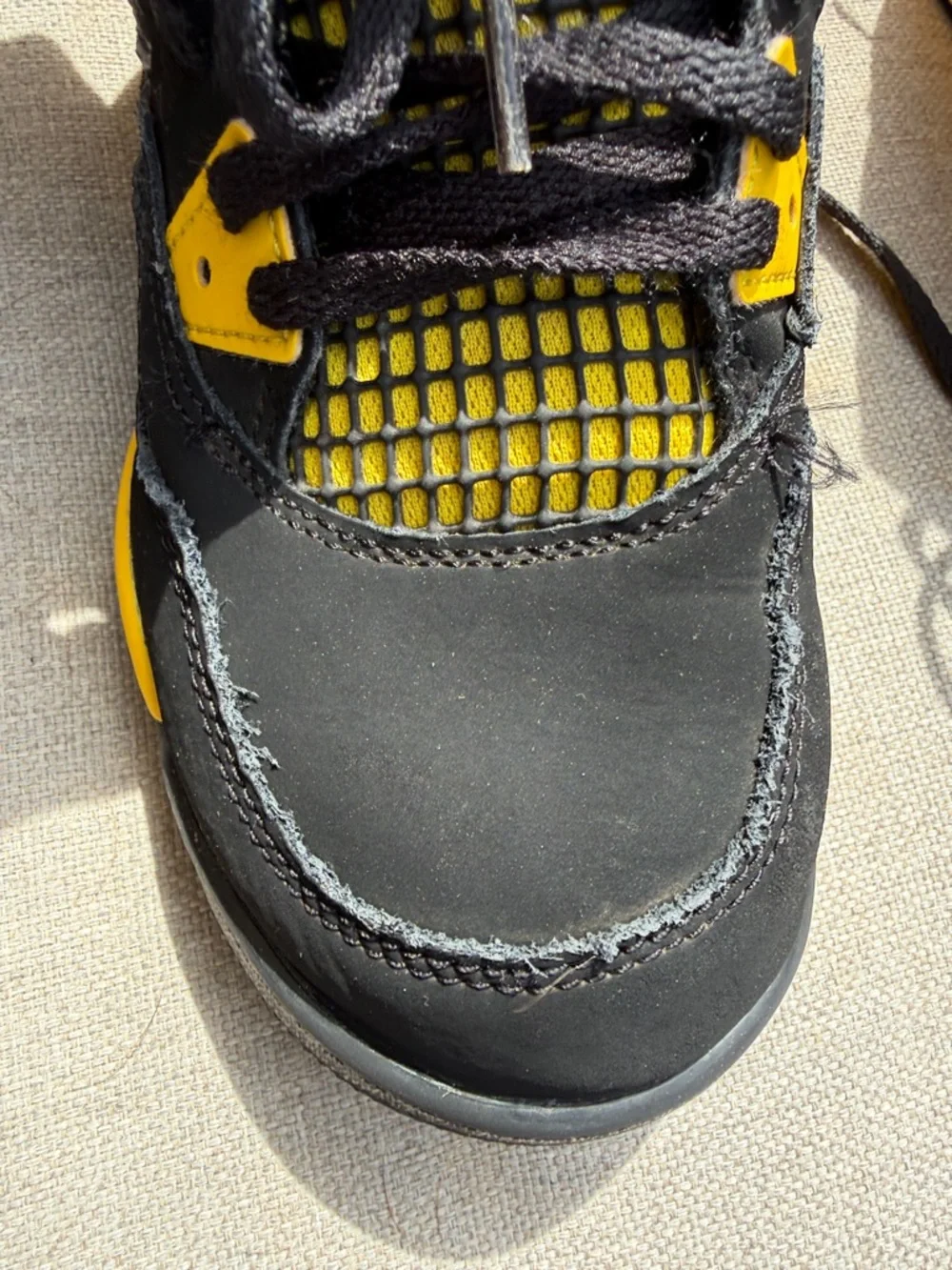 Air Jordan 4 Retro “Thunder” in size 2.5Y GUC.